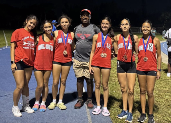 After the meet, some girls from the track team posed with Coach Michel Fotso, happy with the three school records that were broken in this meet.